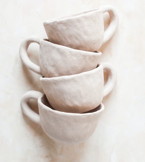 white ceramic mug on white table
